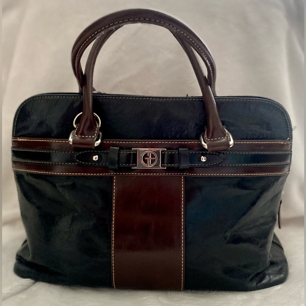 Black leather zip-top purse with brown leather trim.